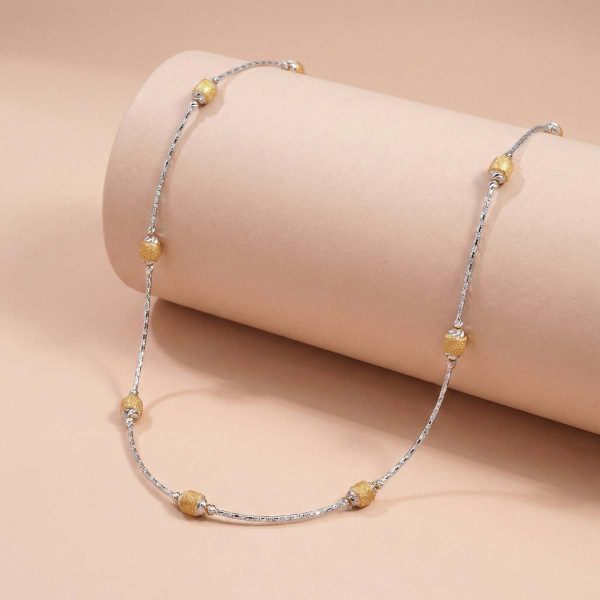 18k two-tone gold minimalist chain with textured yellow gold beads on a beige background - OVJ Jewels