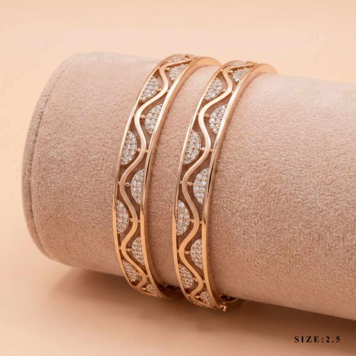 127-25K162--163-size-2 "Pair of 18k gold minimalist bangles featuring a wave cut-out design with small stones, size 2.5, by OVJ Jewels."